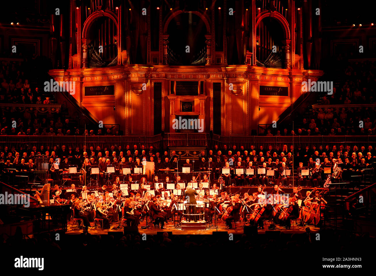 Stephen Barlow conducts the Bournemouth Symphony Orchestra on stage at Classic FM Live at London's Royal Albert Hall. Stock Photo