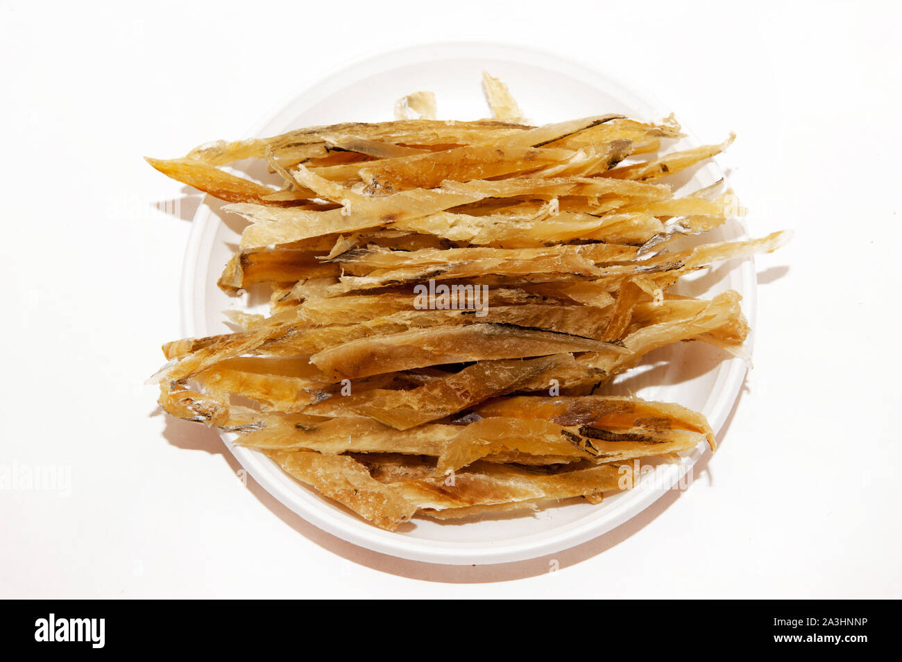 Fish snacks for beer on a plate on a white background Stock Photo