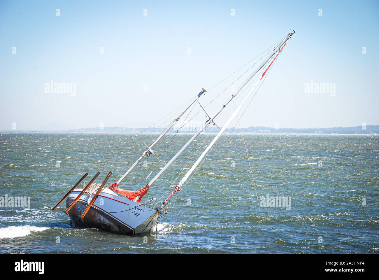 A sailboat on the coast of Punta de Este in front of the center of the Stock Photo