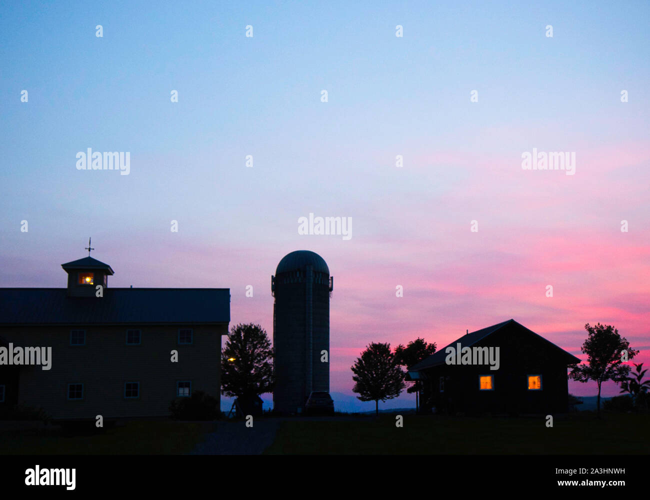 FERRISBURGH, VT JULY 9 Light glow inside a Vermont farmhouse at dusk