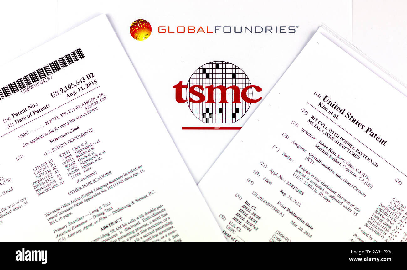 GLOBAL FOUNDRIES vs. TSMC. Logos of the semiconductor companies and two printed US patents which are claimed to be infringed by TSMC. Stock Photo