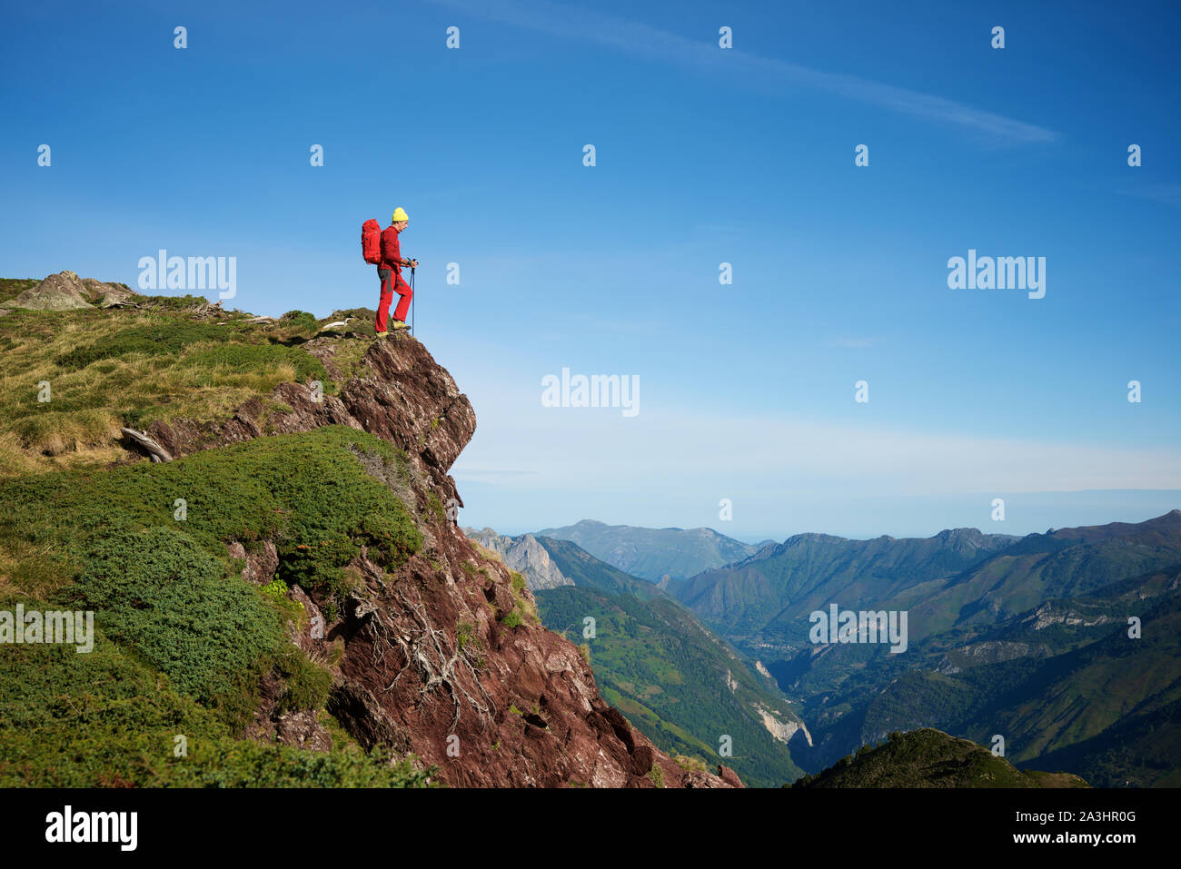 Hiker peeking over a cliff. Stock Photo