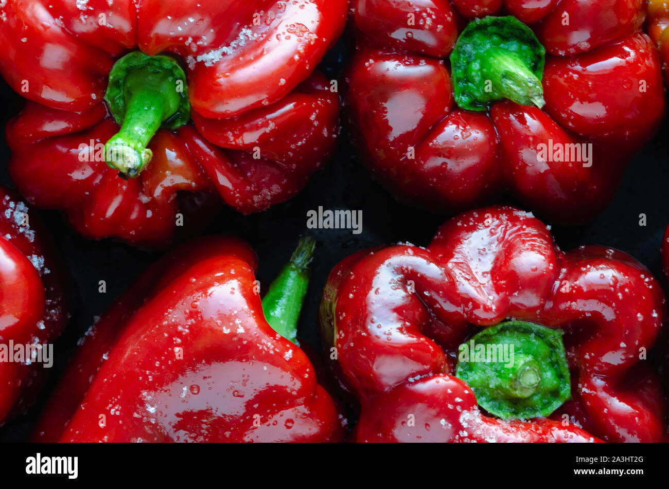 Red peppers on a tray ready to bake. Top view Stock Photo - Alamy