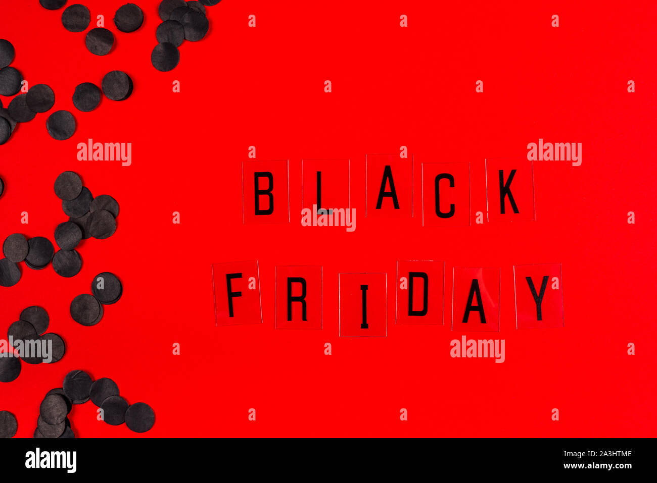 Black Friday sale tag on red background. Stock Photo