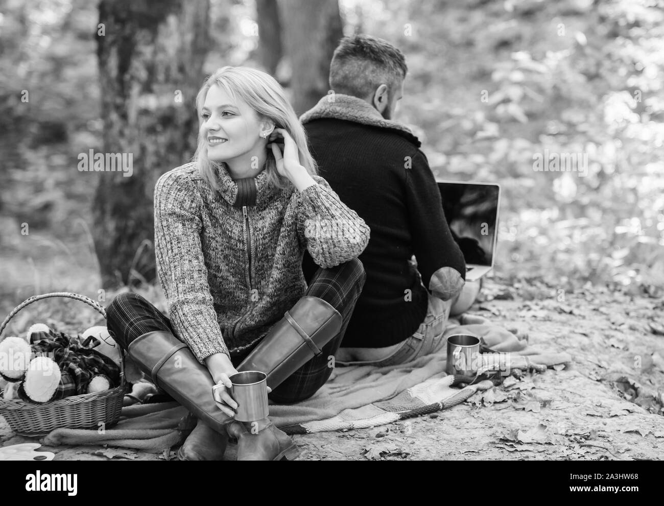 Internet addicted husband. Working on fresh air. Surfing internet. Happy loving couple relaxing in park with laptop. Always at work. Man freelance worker internet addicted gamer with laptop forest. Stock Photo