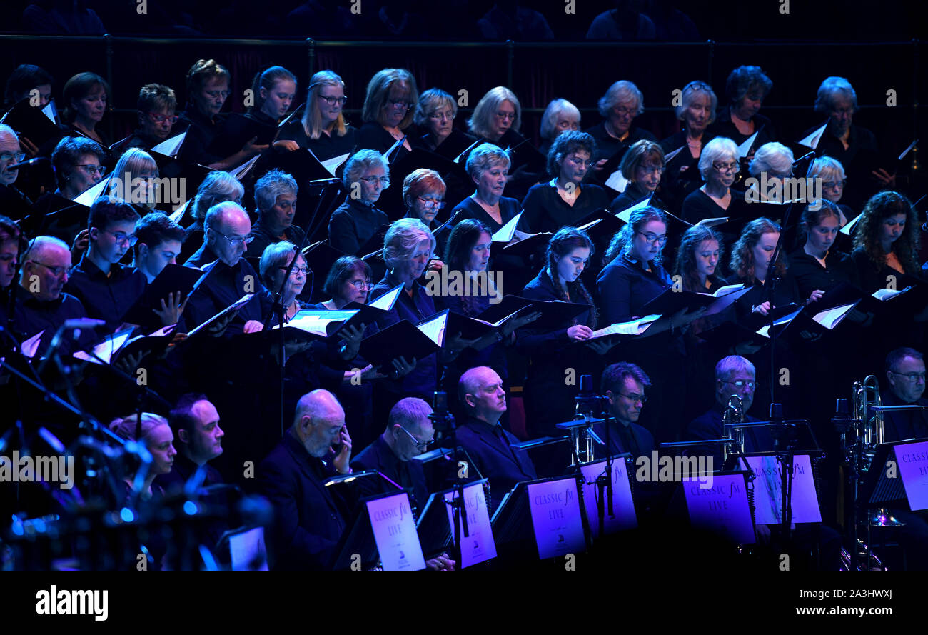 Stephen Barlow conducts the Bournemouth Symphony Orchestra and Chorus on stage at Classic FM Live at London's Royal Albert Hall. Stock Photo