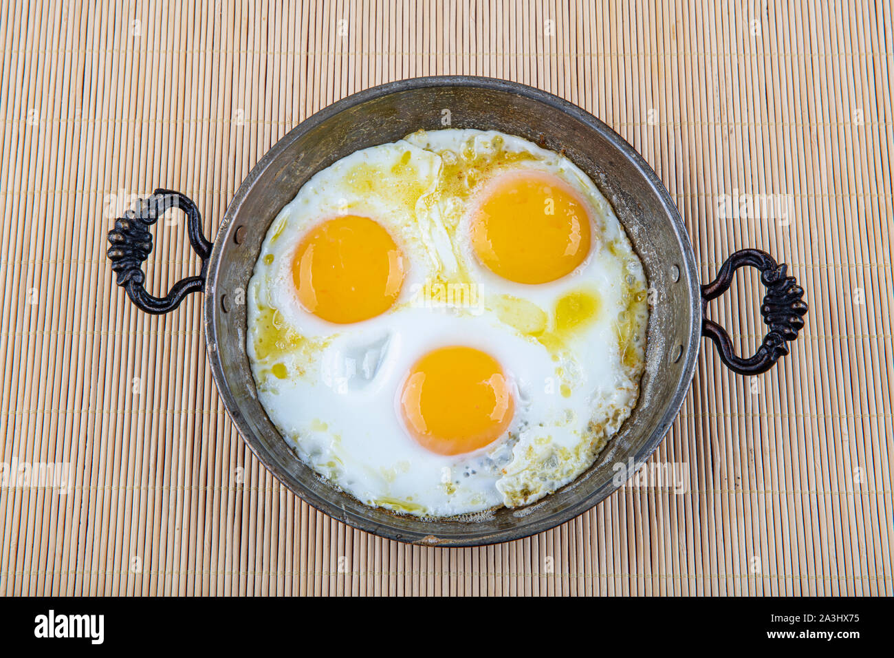 Fried egg. Close up view of the fried egg on a frying pan. Restaurant ...