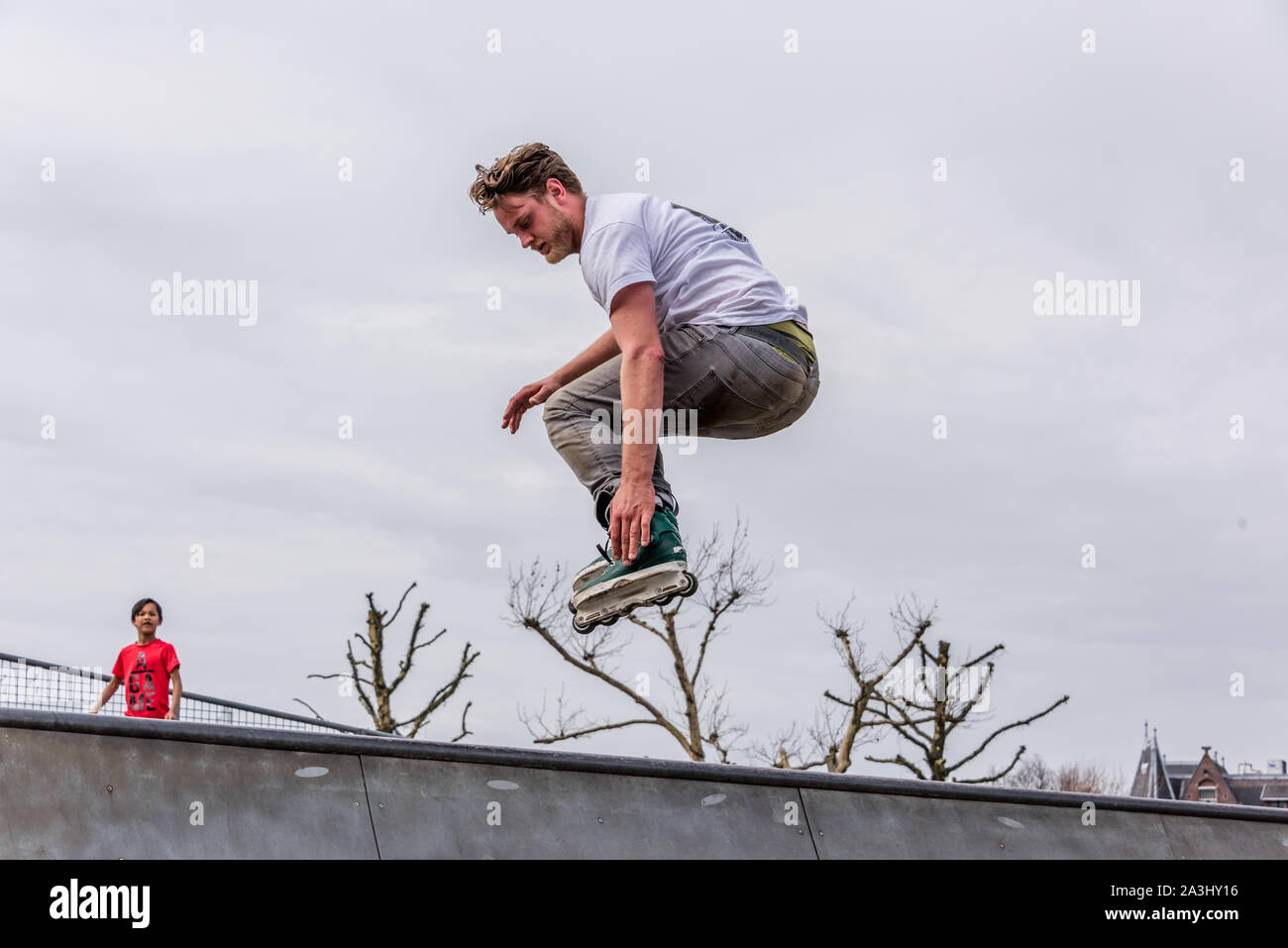 Amsterdam, Holland, October 2019, roller skater on half pipe flying ...