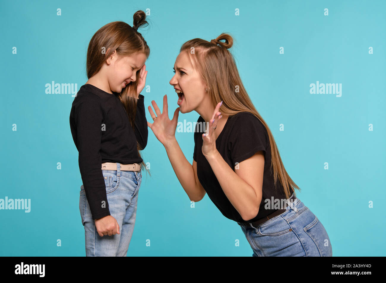 Mom And Daughter With A Funny Hairstyles Dressed In Black
