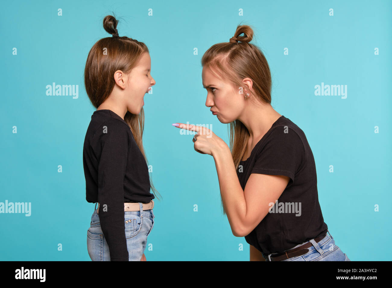 Mom And Daughter With A Funny Hairstyles Dressed In Black