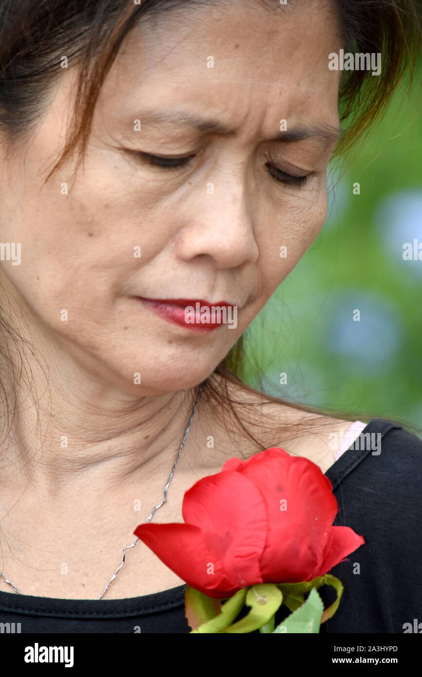 Sad Female Senior Granny With Flowers Stock Photo