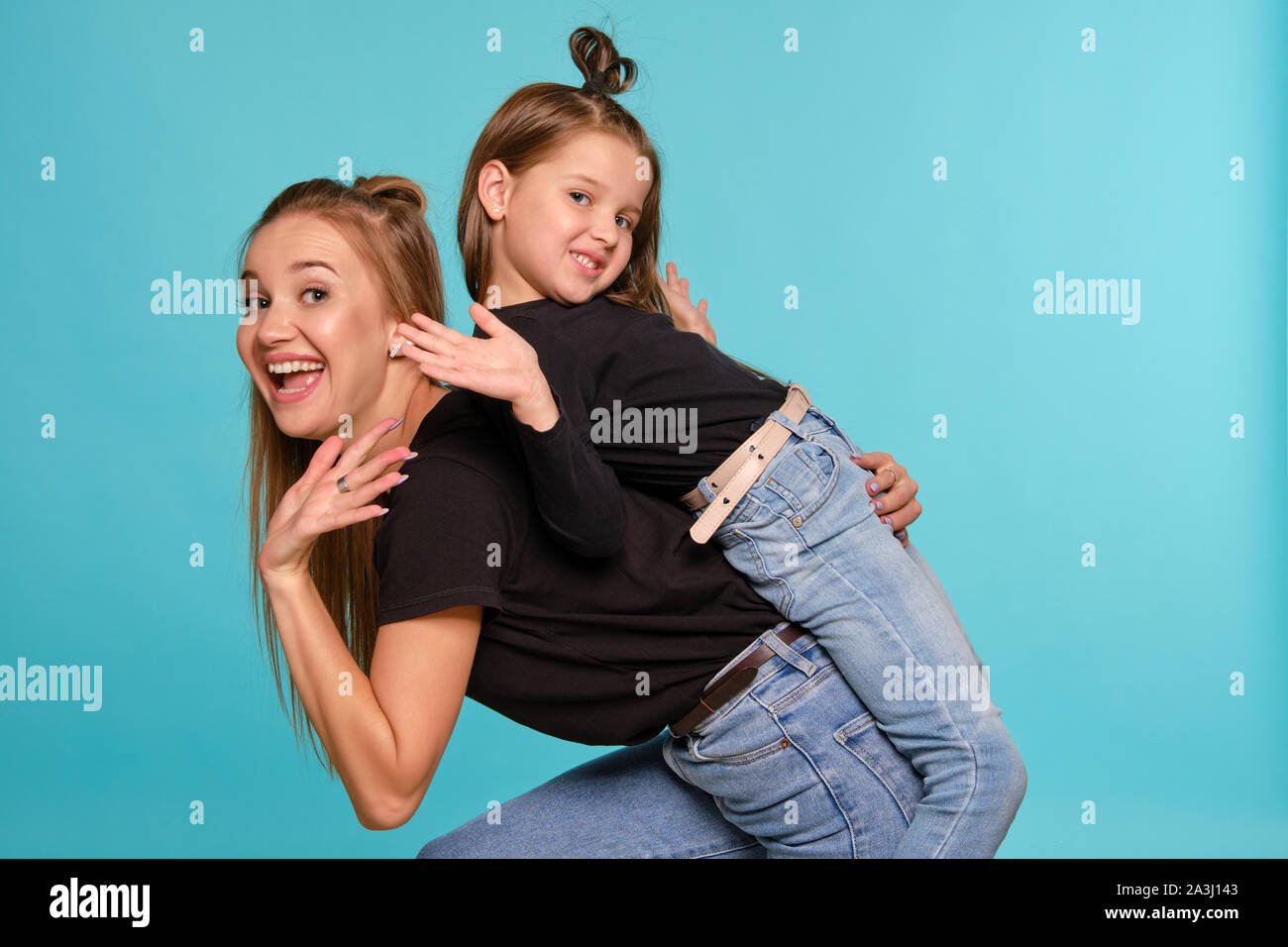 Mom And Daughter With A Funny Hairstyles Dressed In Black Shirts