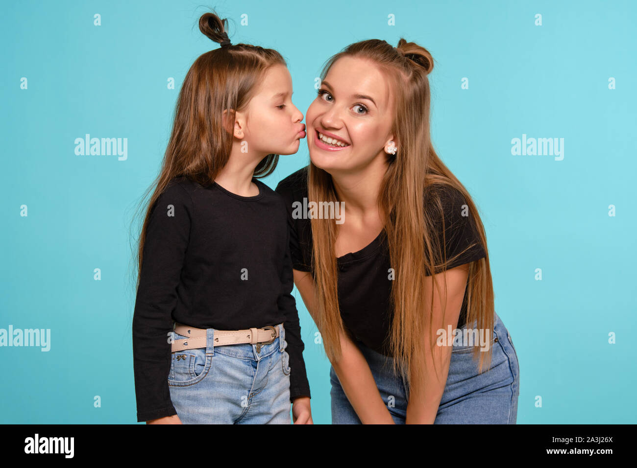 Mom And Daughter With A Funny Hairstyles Dressed In Black Shirts