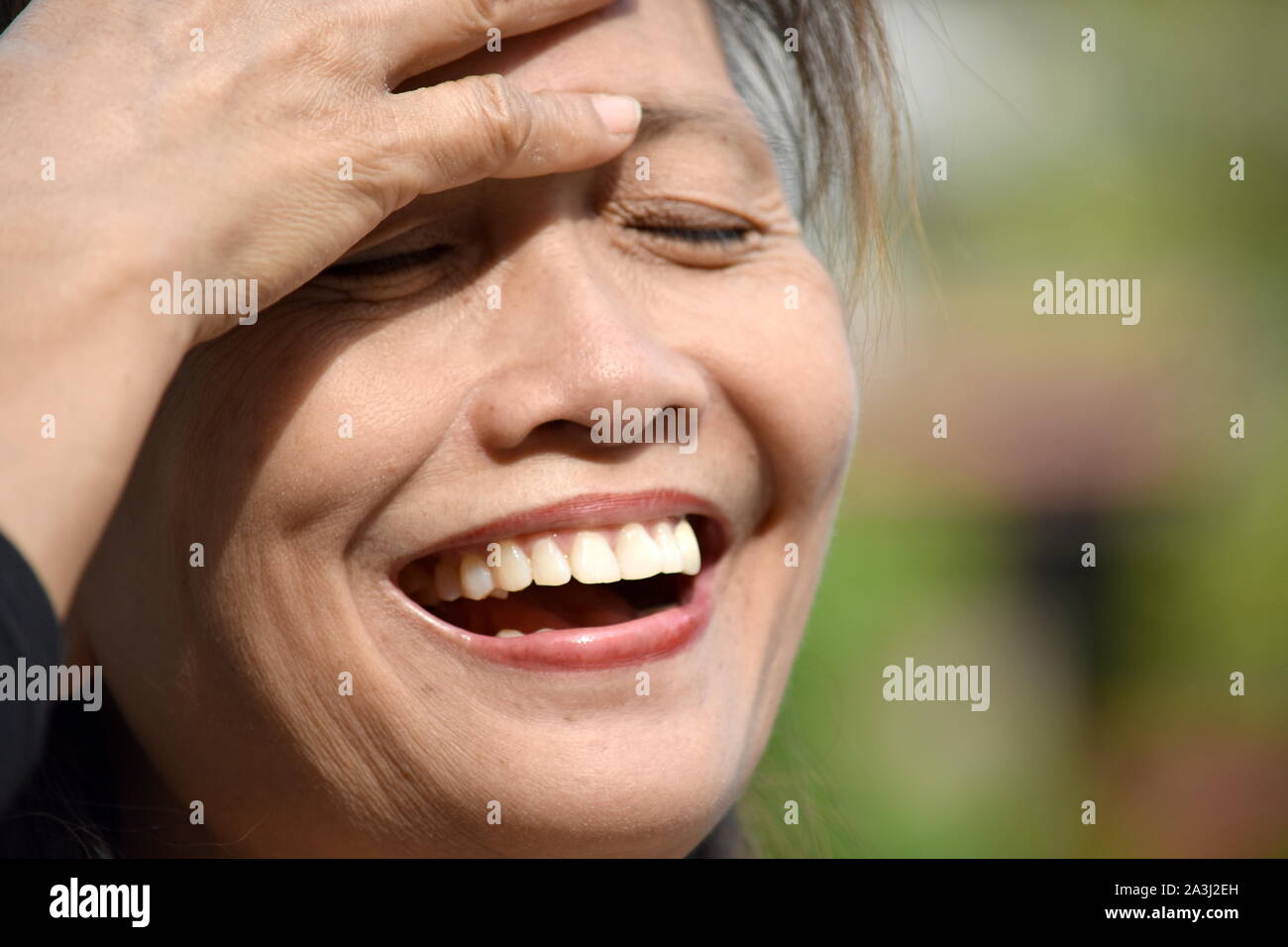 A Laughing Old Asian Female Senior Stock Photo