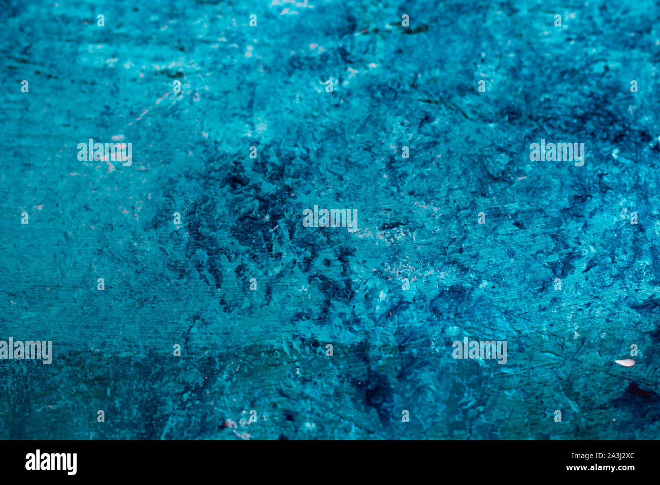 Abstract rough textured concrete wall pained with blue and mint green acrylic paint Stock Photo
