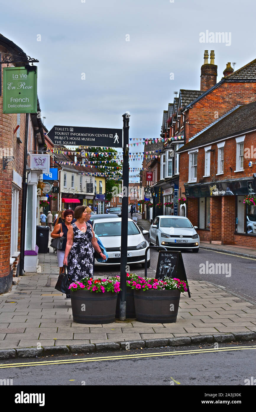 A view looking down East Street Wimborne. People walking along pavement. Tourist