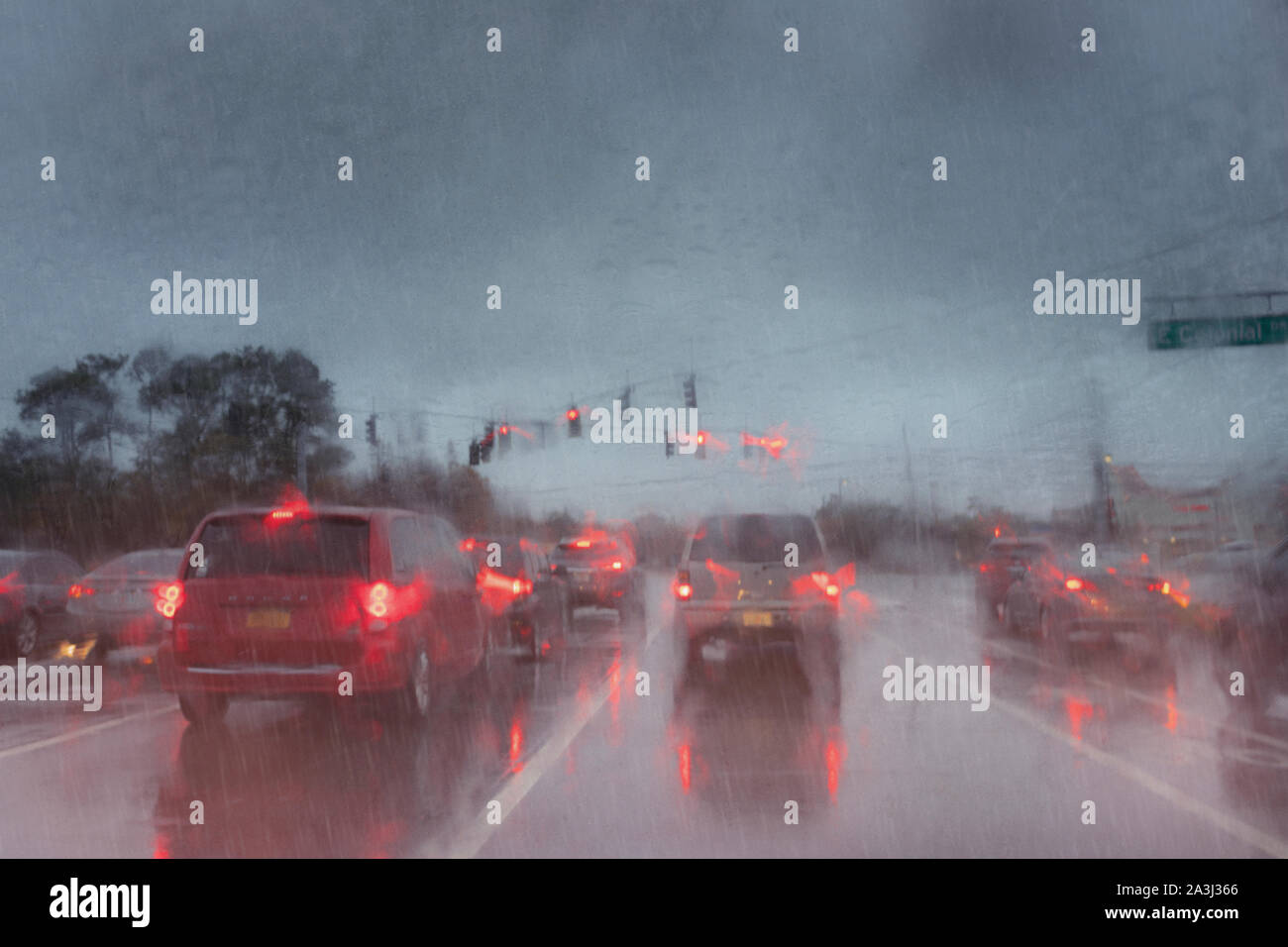 Rainy weather on the road seen through blurry rain streaked windshield Stock Photo