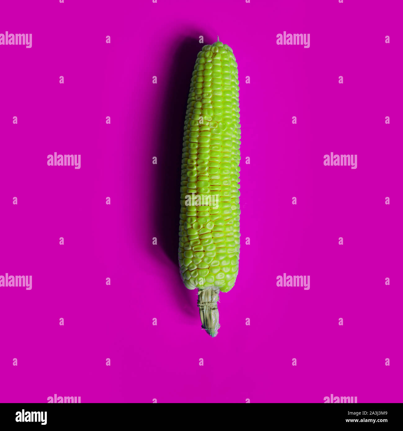 Creative corn vibrant colors on background.Topview. Flat lay. Food concept. Macro concept. Stock Photo