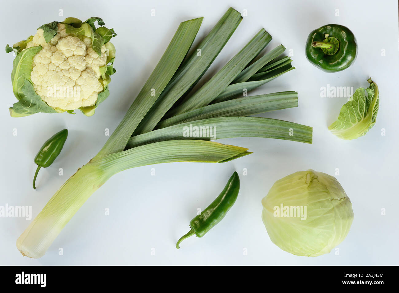 Creative layout made of zucchini leek cauliflower green and chili pepper . Flat lay. Food concept. Green vegetables isolated on white background Stock Photo