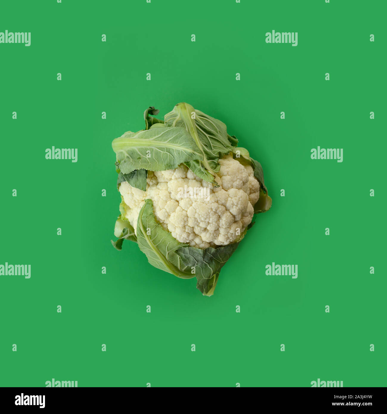 Head of cauliflower on green background Stock Photo