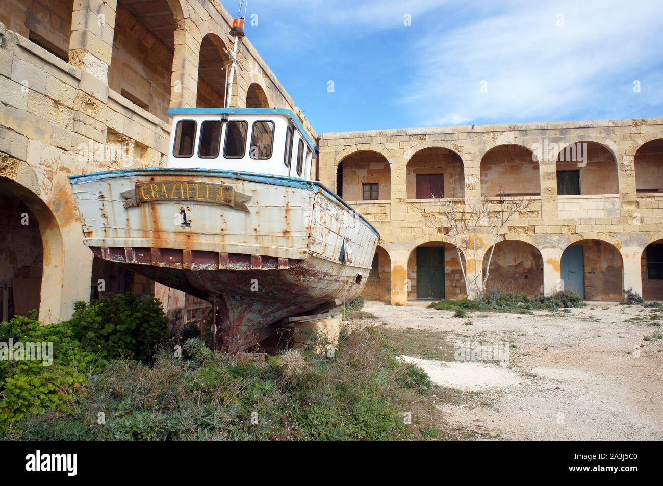 Quarantine and hospital building on Comino with abandoned boat, Malta