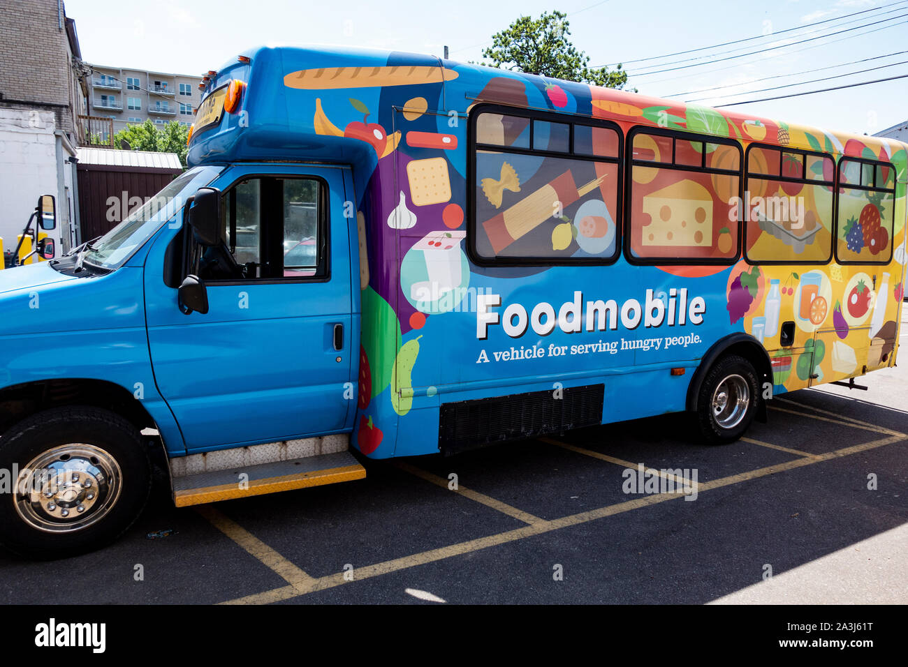 Brightly painted Foodmobile bus parked at a food shelf waiting to deliver food to hungry people. St Paul Minnesota MN USA Stock Photo