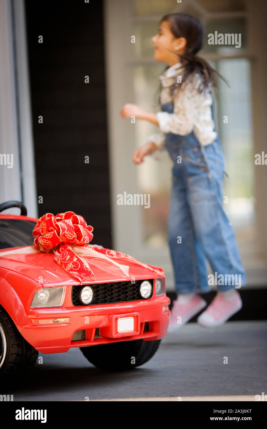 Happy young girl with her small red car Stock Photo - Alamy