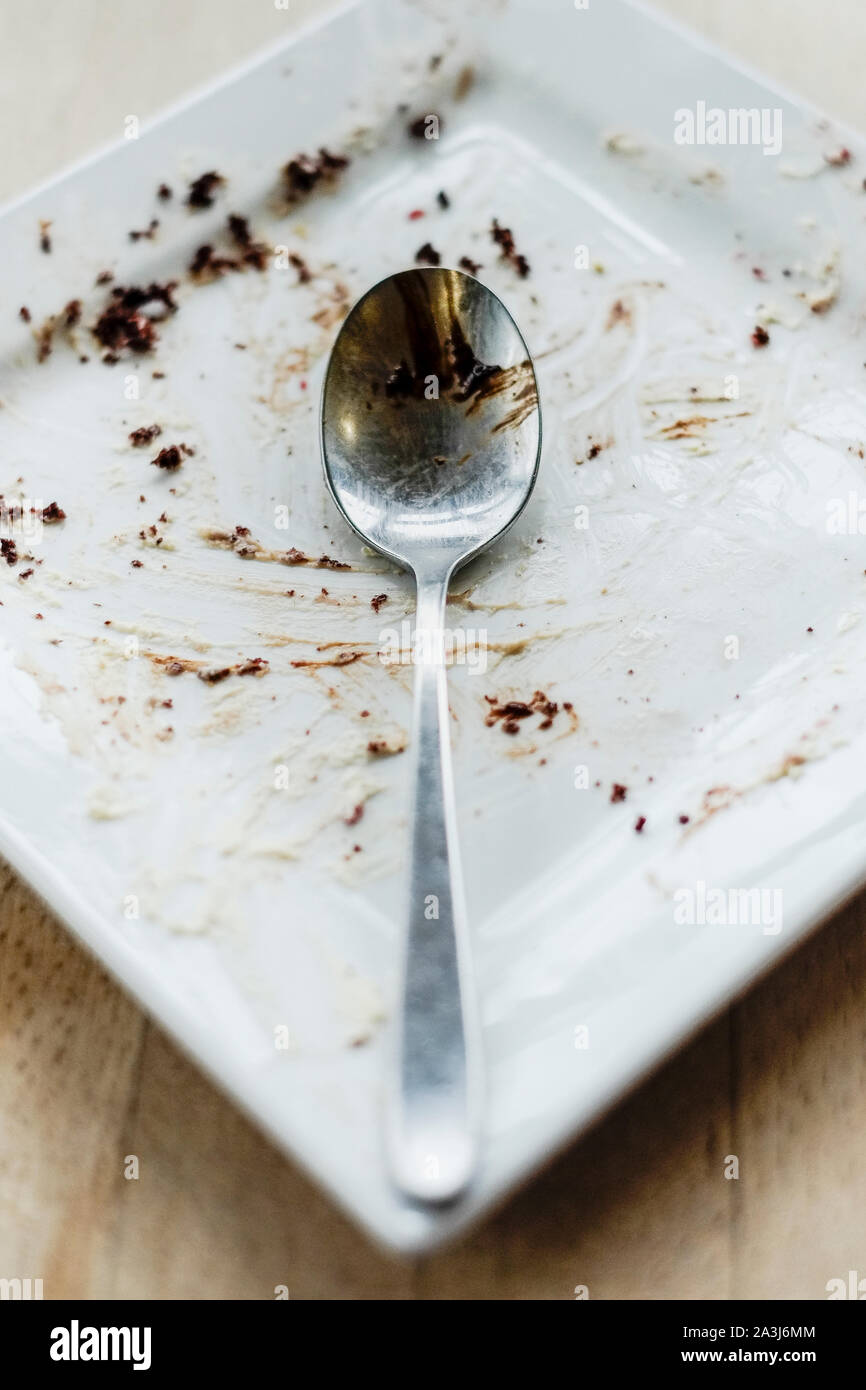 An empty plate after a chocolate dessert has been eaten in a restaurant. Stock Photo