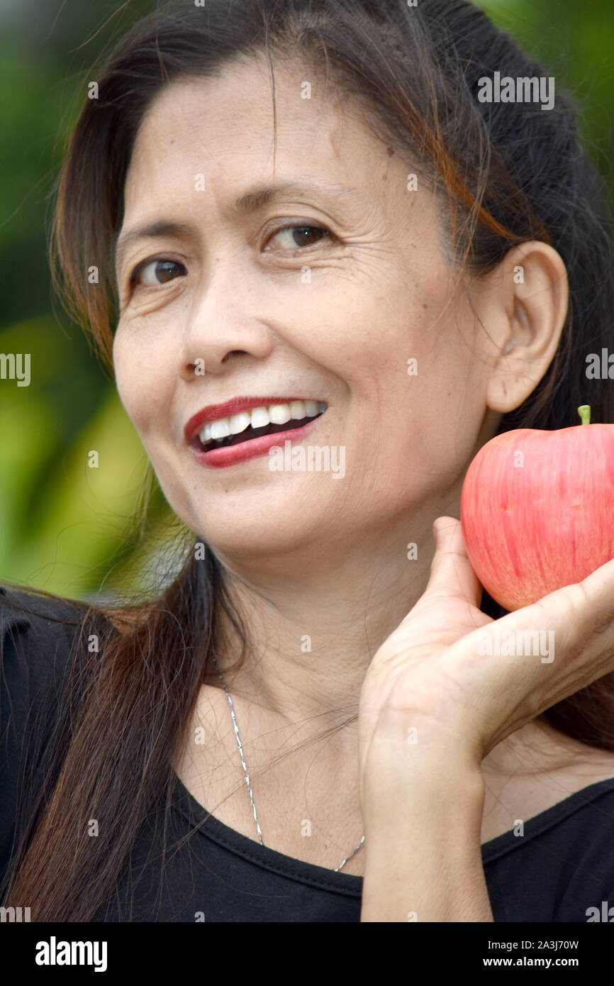 Smiling Older Female Senior With Apples Stock Photo