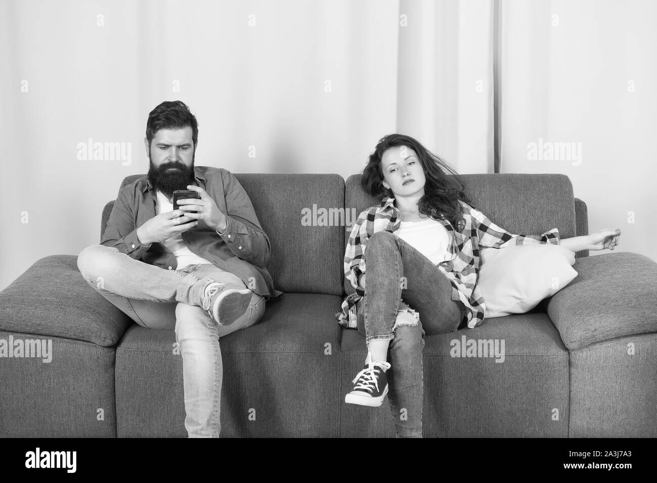 Mobile gadget dependence. Man bearded hipster play smartphone while girlfriend relaxing near. Internet surfing and social networks. Mobile internet addiction. Husband addicted internet online games. Stock Photo