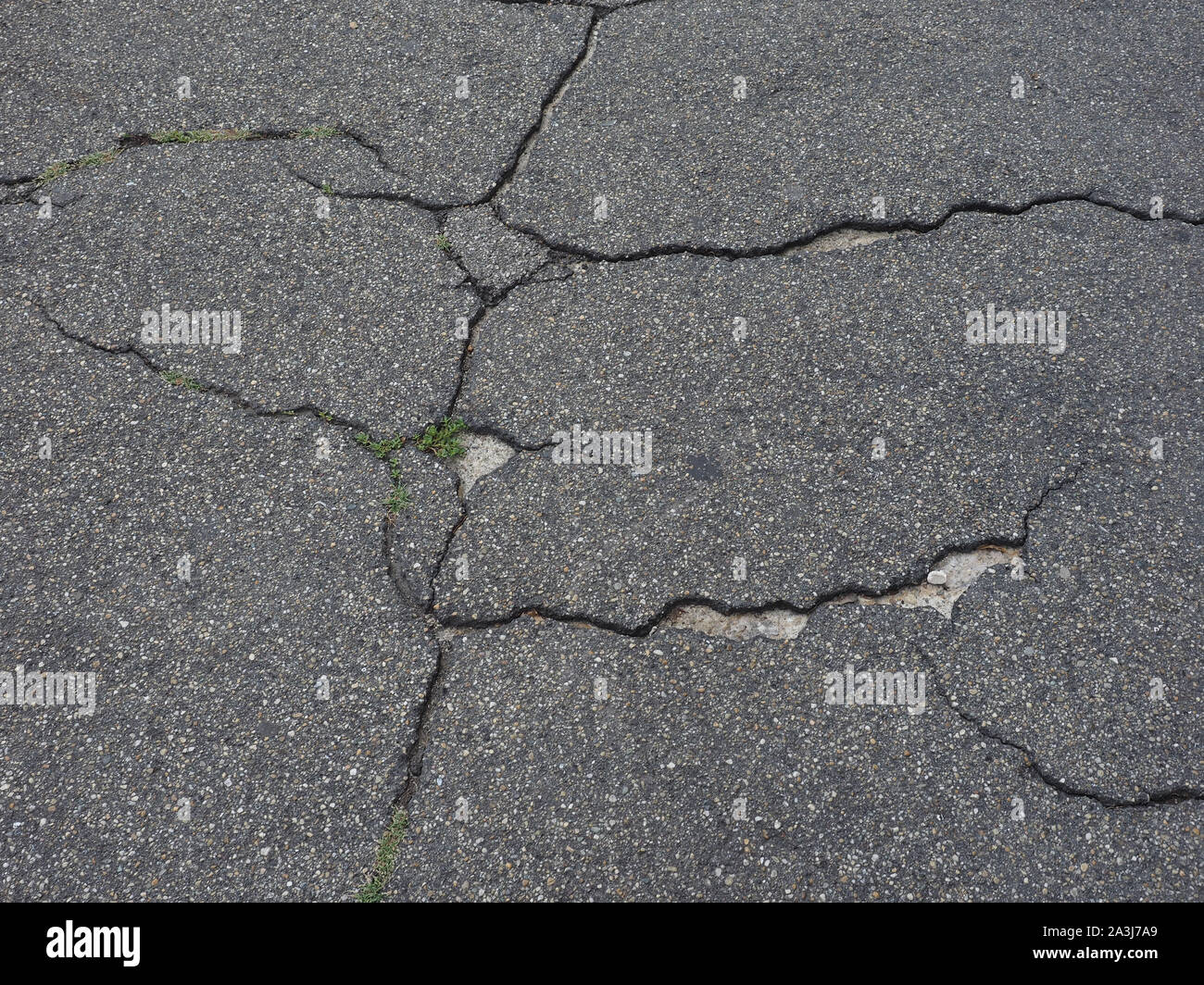 cracked black tarmac texture useful as a background Stock Photo