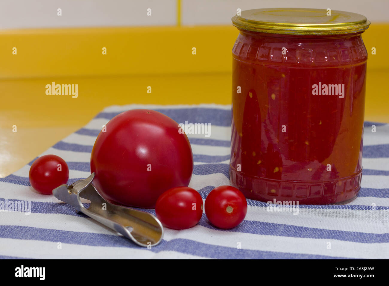Vitamins on yellow table, tomato, cherry and tomato paste in glass jar