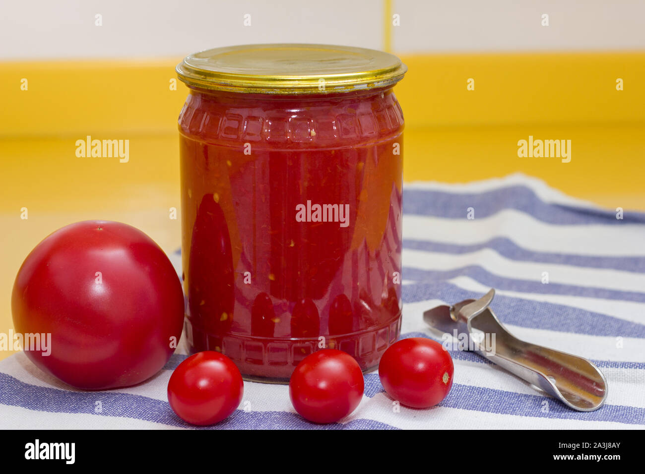 Vitamins on yellow table, tomato, cherry and tomato paste in glass jar