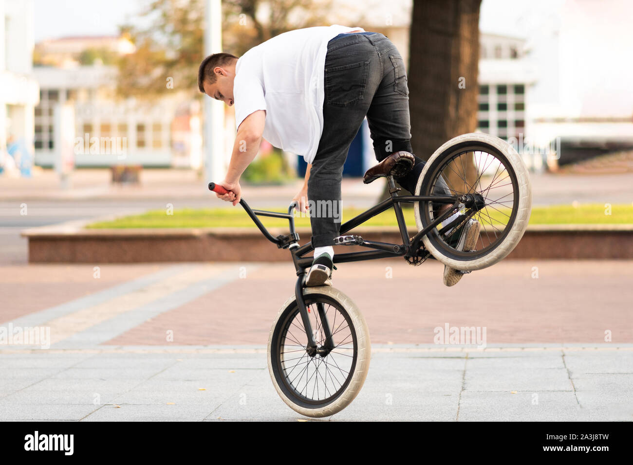 The guy on the BMX bike performs a 