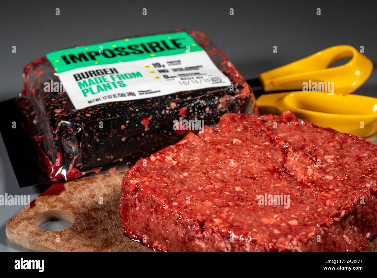 MORGANTOWN, WV - 8 October 2019: Packaging for Impossible Foods burger made from plants with raw product on steel background Stock Photo