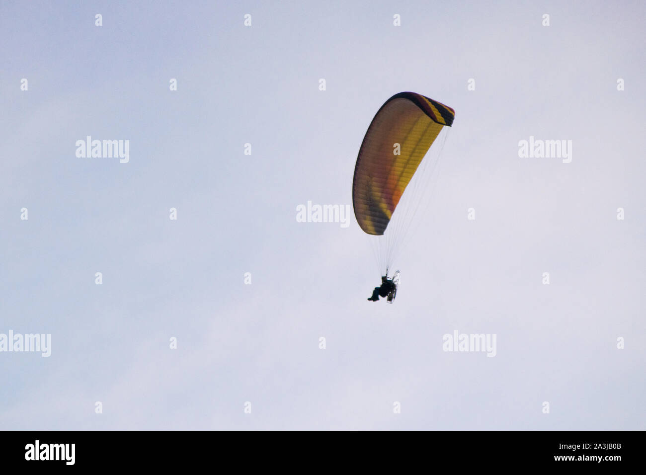 Low angle of a paraglider flying in the clear sky Stock Photo
