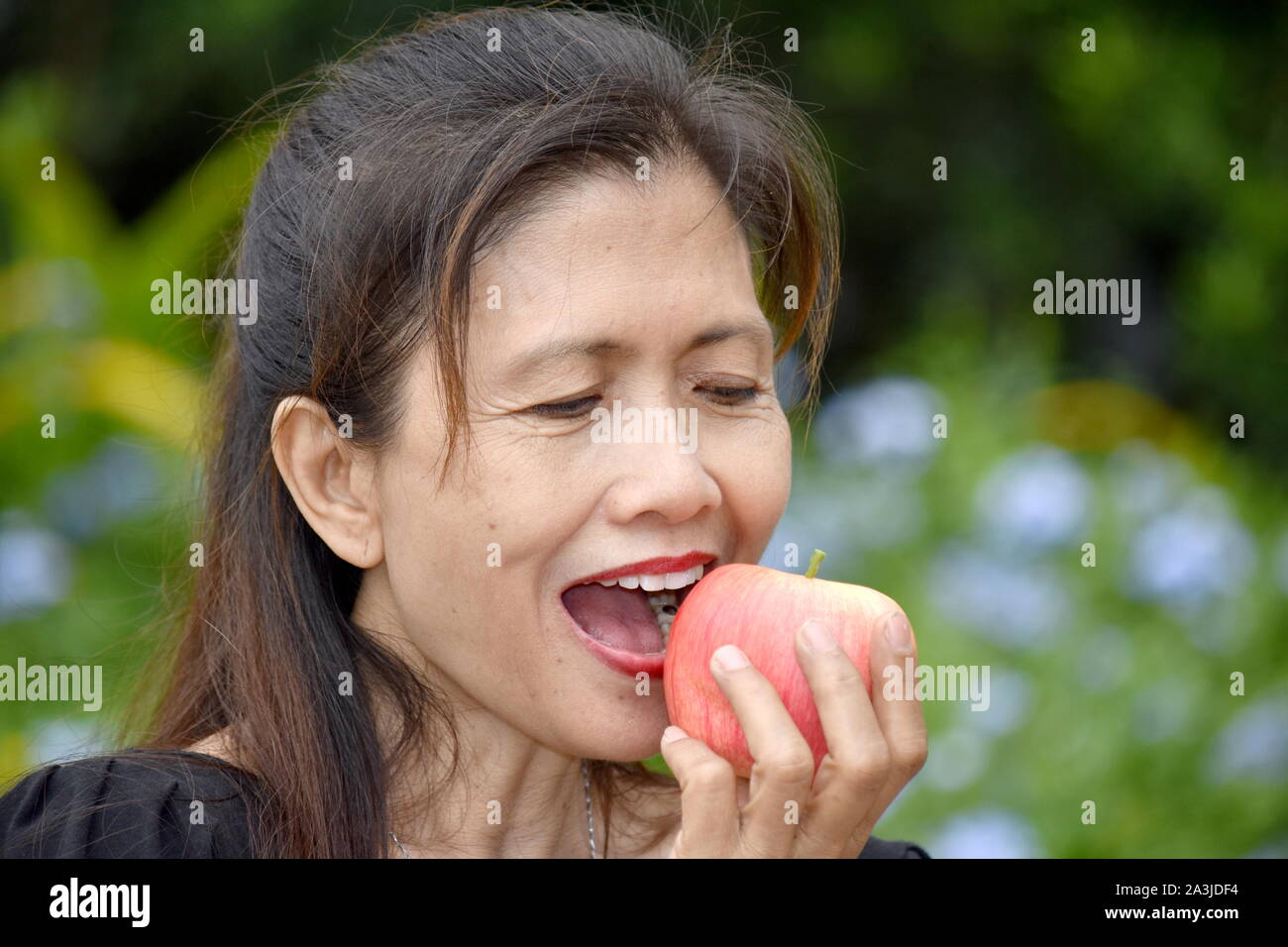 Old lady eating apple hires stock photography and images Alamy