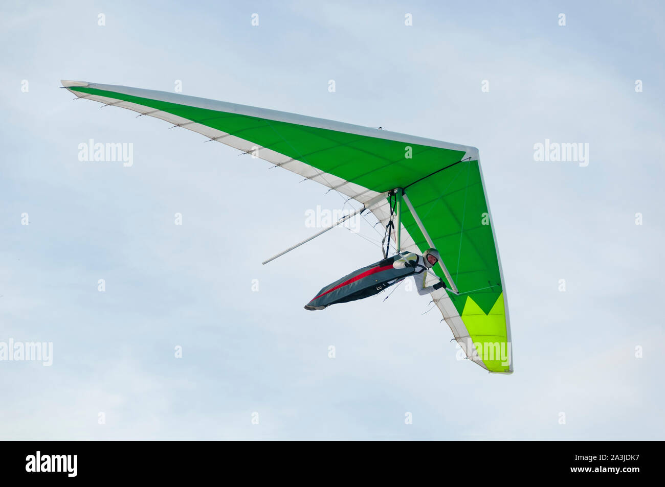 Hang glider wing silhouette. Pilot flies with his green kite wing Stock Photo