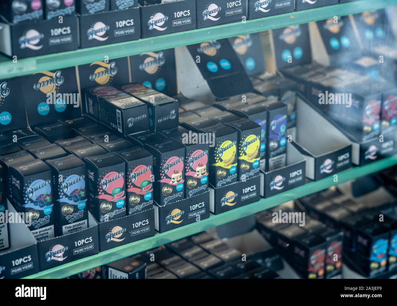 london-uk-4-october-2019-many-brands-of-flavored-nicotine-for-e-cigarettes-in-shop-with-reflection-of-street-in-window-2A3JEF9.jpg