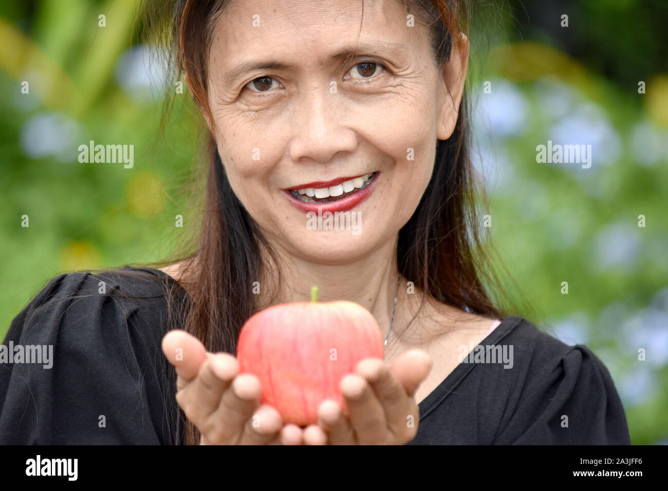 Happy Female Senior Grandma With Fruit Stock Photo