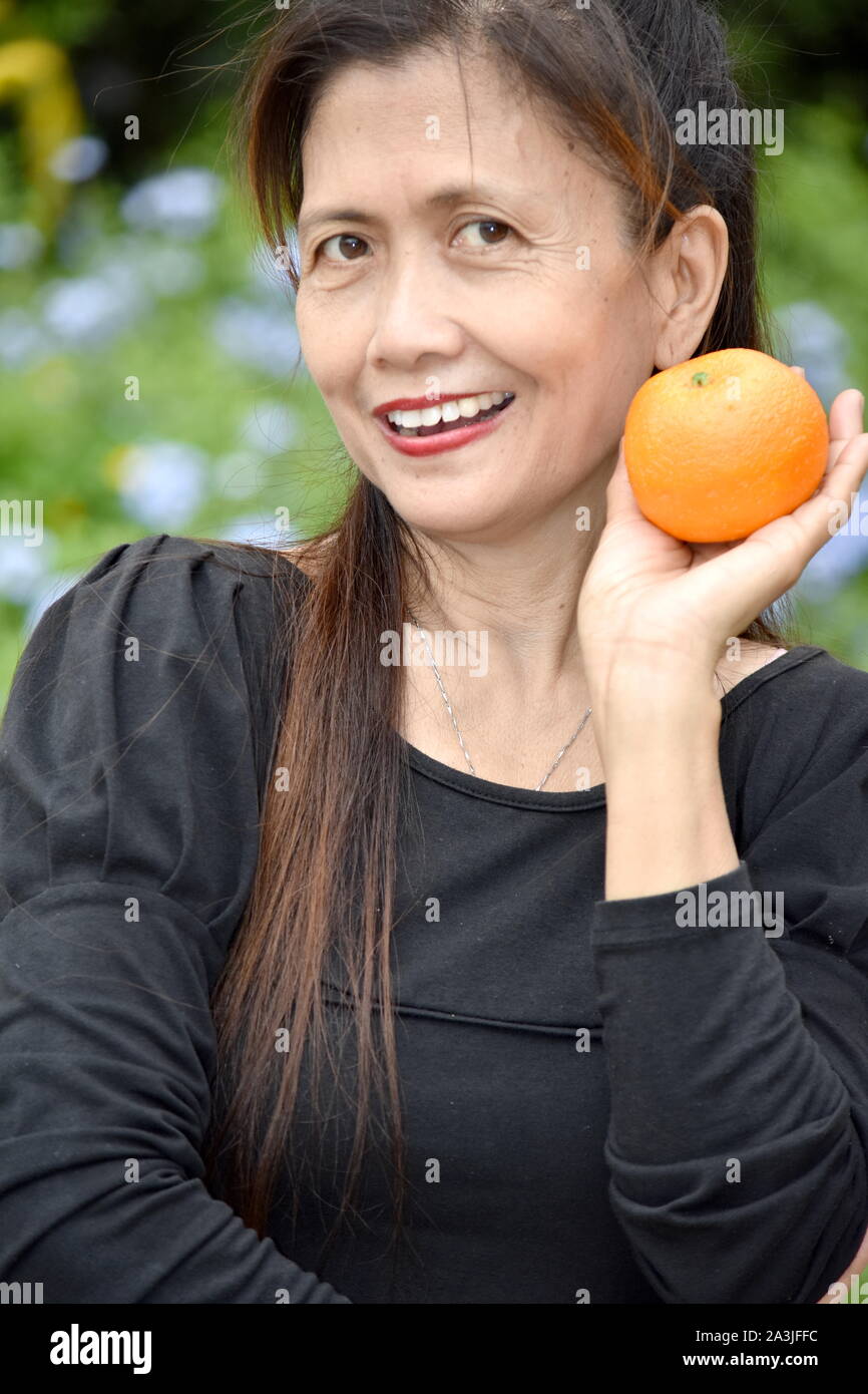 Happy Older Asian Female Senior With Fruit Stock Photo