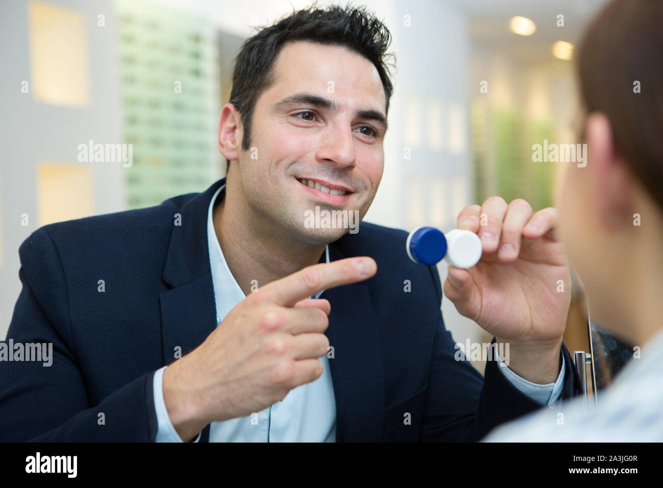 eye doctor showing lenses to customer Stock Photo Alamy