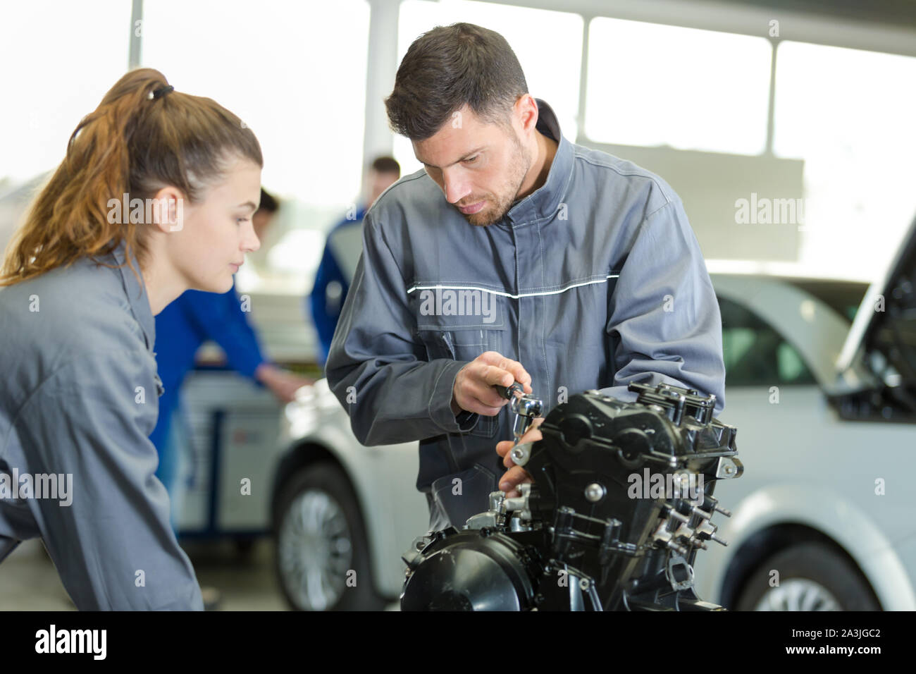 female auto mechanic learning to fix an engine Stock Photo Alamy