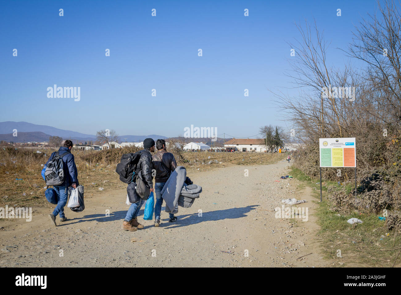 GEVGELIJA, MACEDONIA - DECEMBER 13, 2015  Refugees standing at the entrance of Vinojug camps near the city of Eidomeni Idomeni in Greece on the border Stock Photo