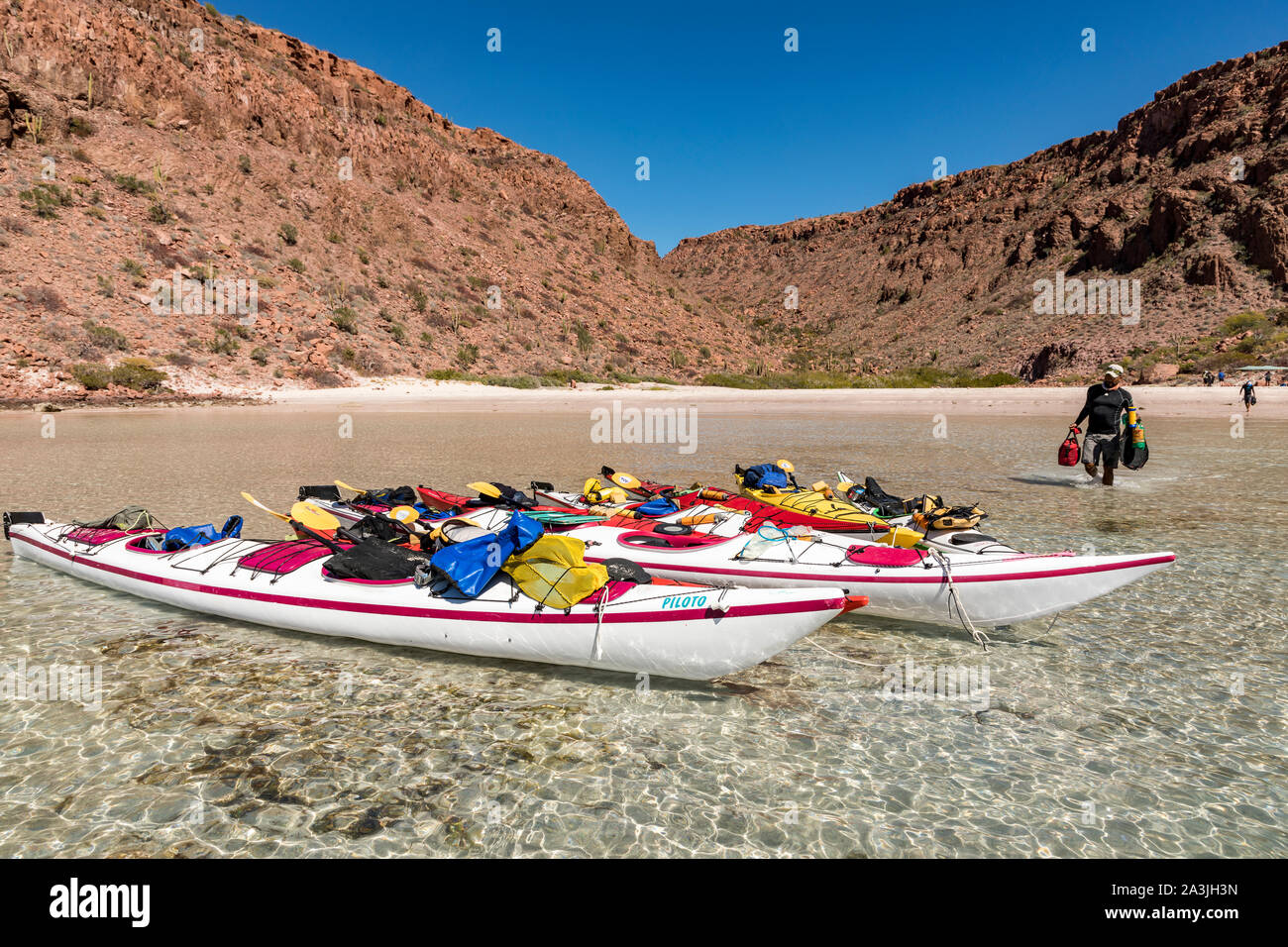 A Kayak guide loads sea kayaks in a bay off Isla Espíritu Santo in the