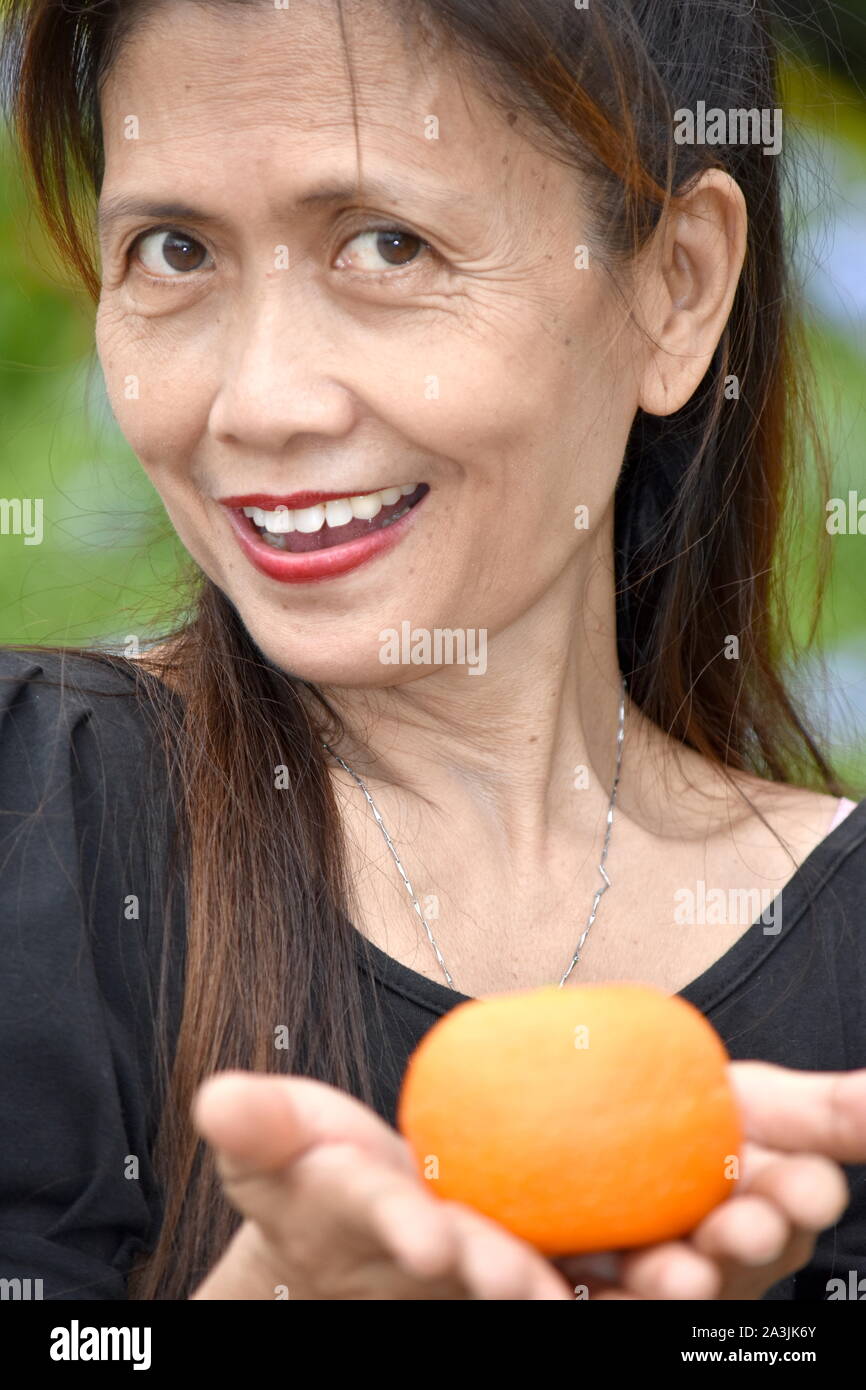 Smiling Retired Diverse Female Senior With Food Stock Photo
