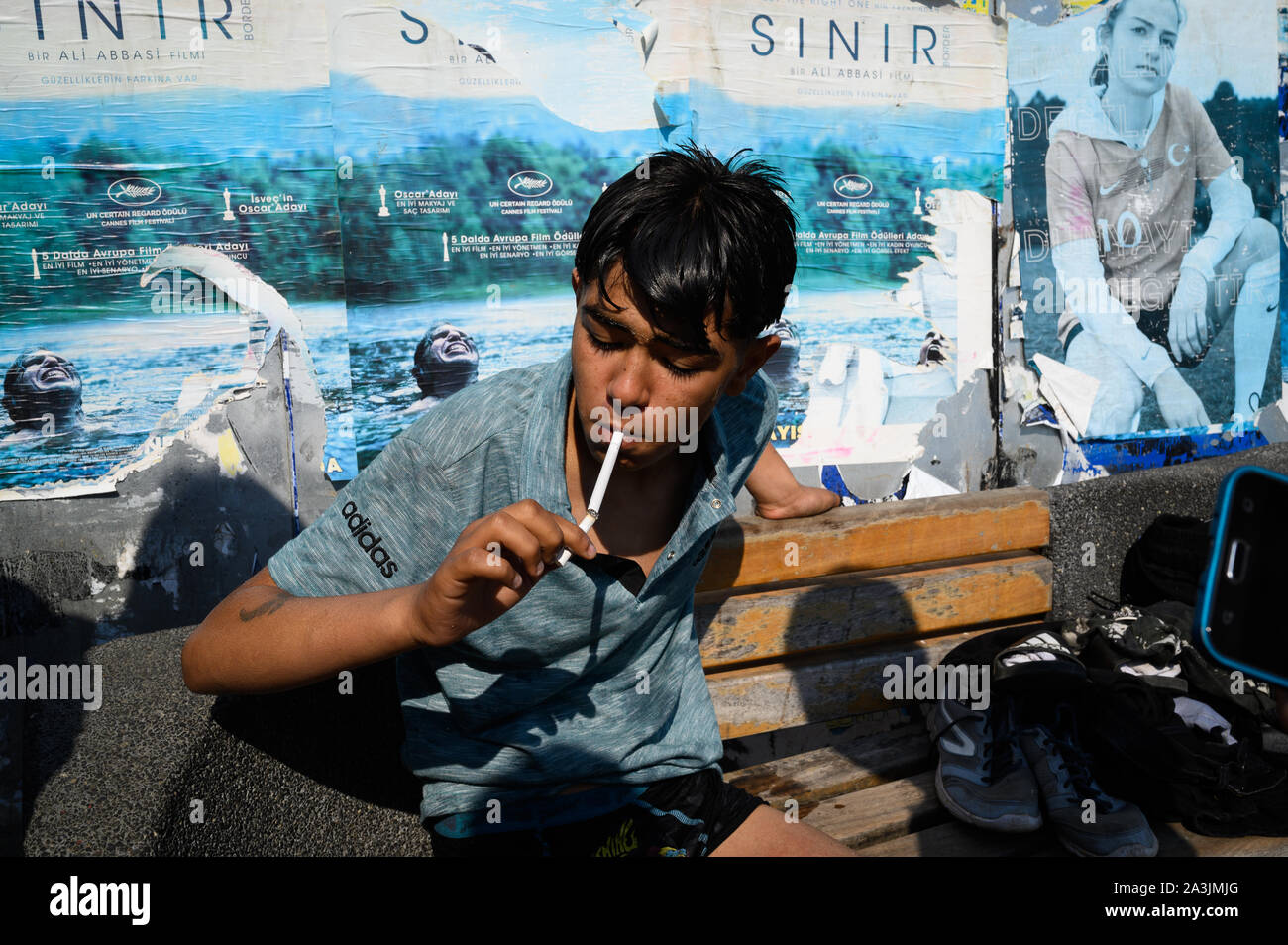 Portrait of a boy smoking near Galata Bridge, Istanbul, Turkey Stock Photo