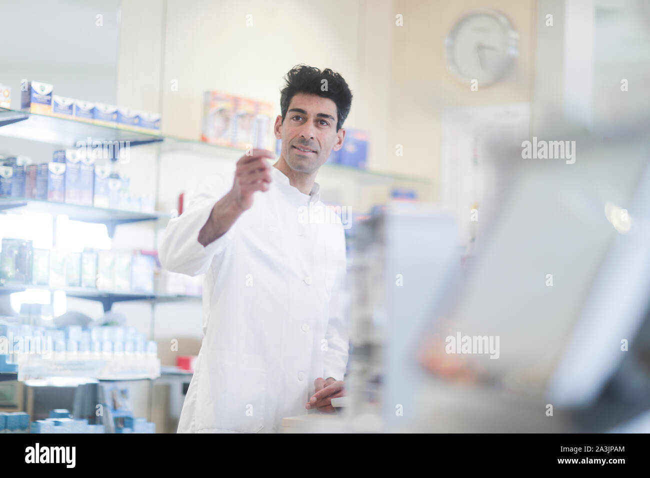 pharmacist in a pharmacy with a tablet Stock Photo