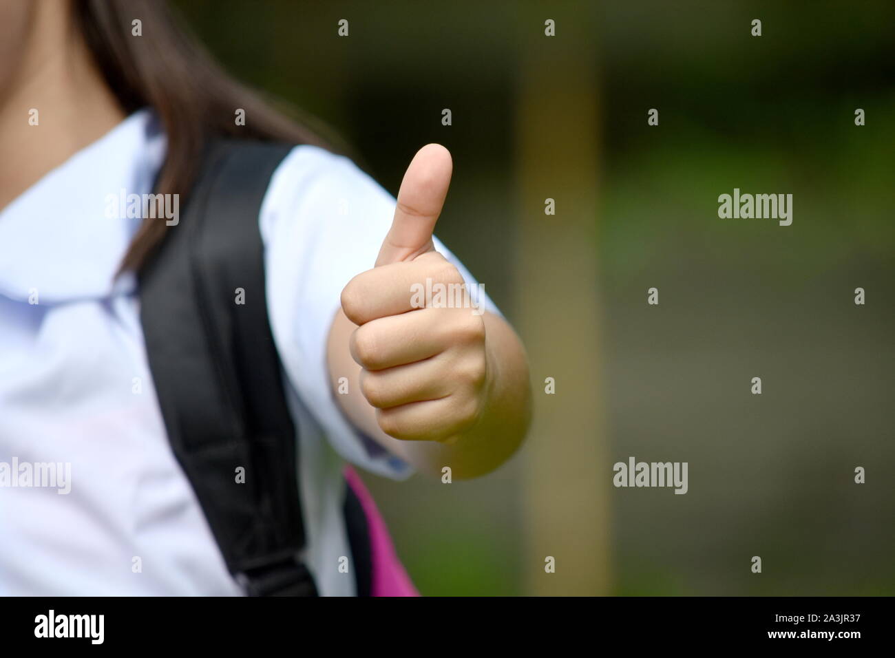 Child Girl Student With Thumbs Up Wearing Uniform Stock Photo - Alamy