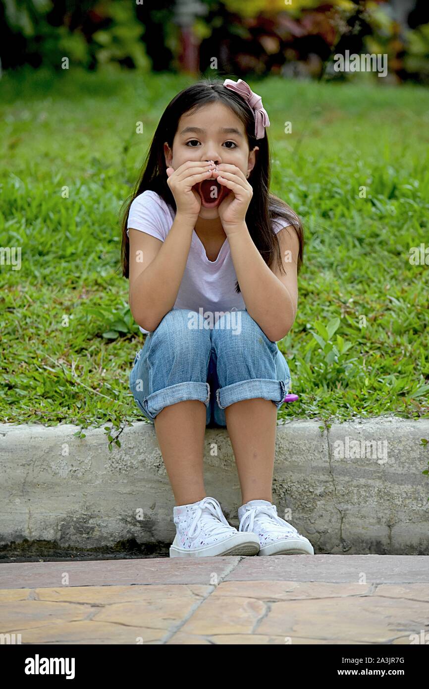 A Cute Minority Girl Yelling Stock Photo